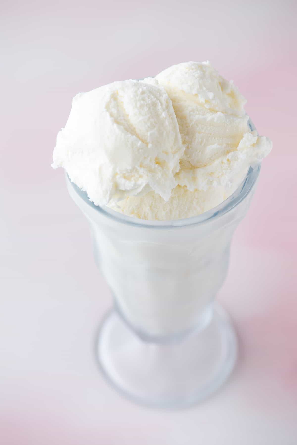 a tall glass cup filled with vanilla ice cream