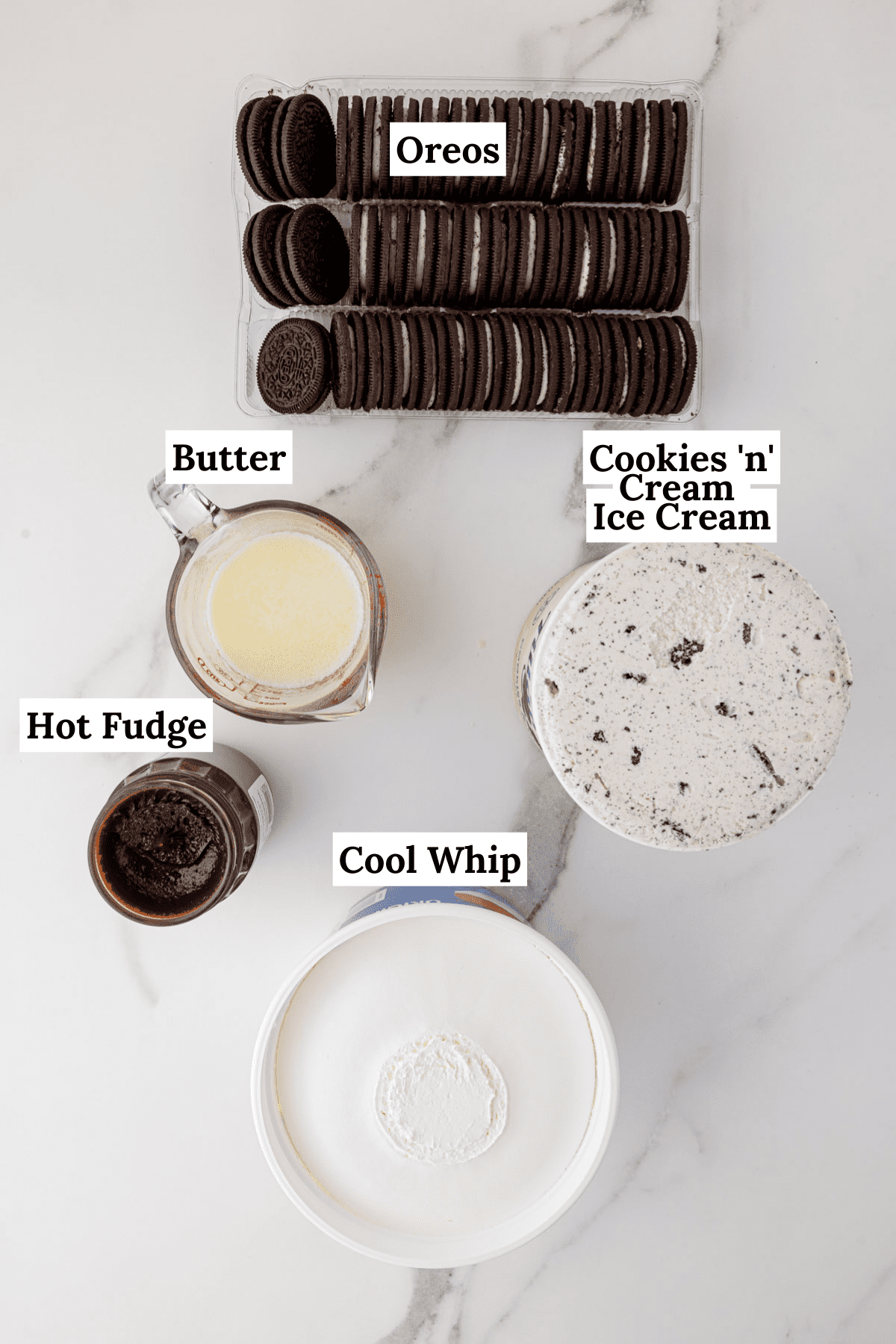 ingredients for oreo ice cream cake including butter, hot fuge, cookies and cream ice cream, cool whip and oreos