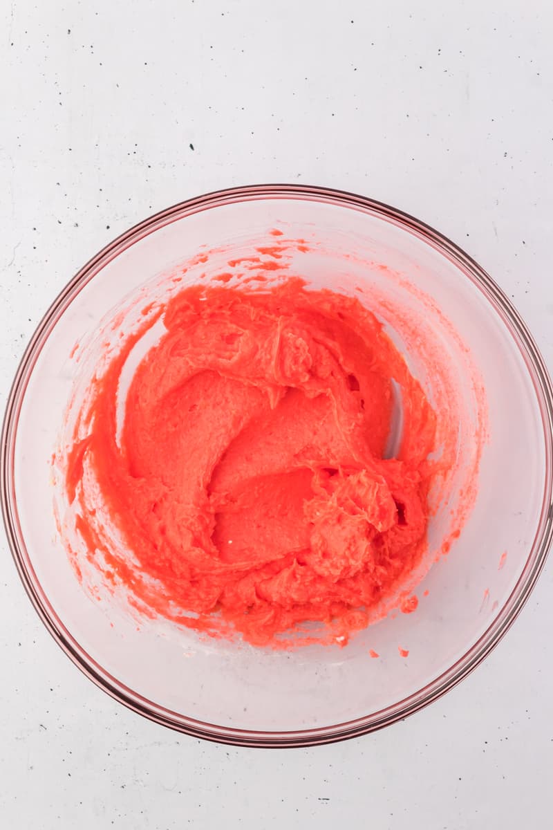 yogurt, strawberry jello and vanilla pudding powder mixed together in a glass bowl