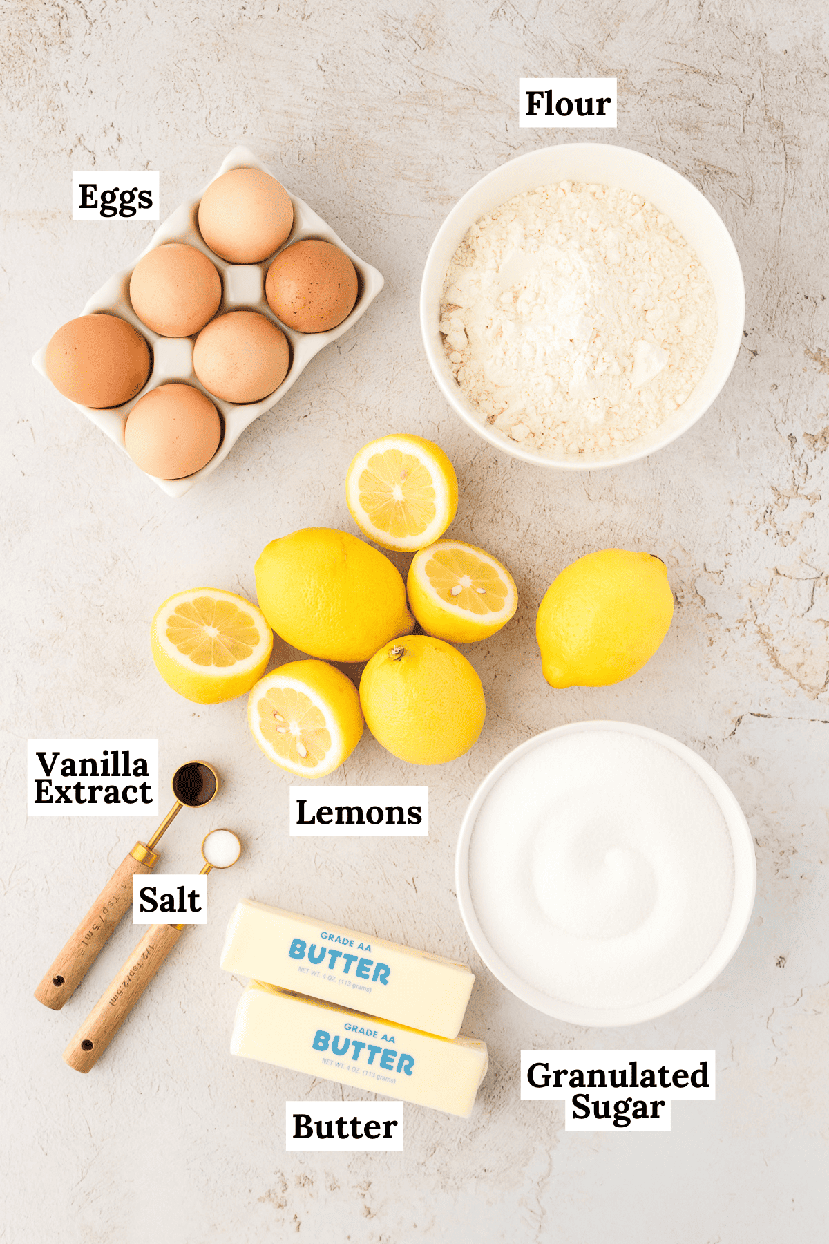 ingredients for lemon bars including eggs, flour, lemons, vanilla extract, granulated sugar, butter, vanilla extract and salt
