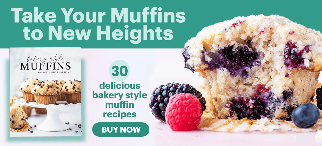 A bakery cookbook promotion features a close-up of a berry muffin with fresh blackberries and raspberries beside it. Text reads: Take Your Muffins to New Heights—30 delicious bakery style muffin recipes. Buy Now.