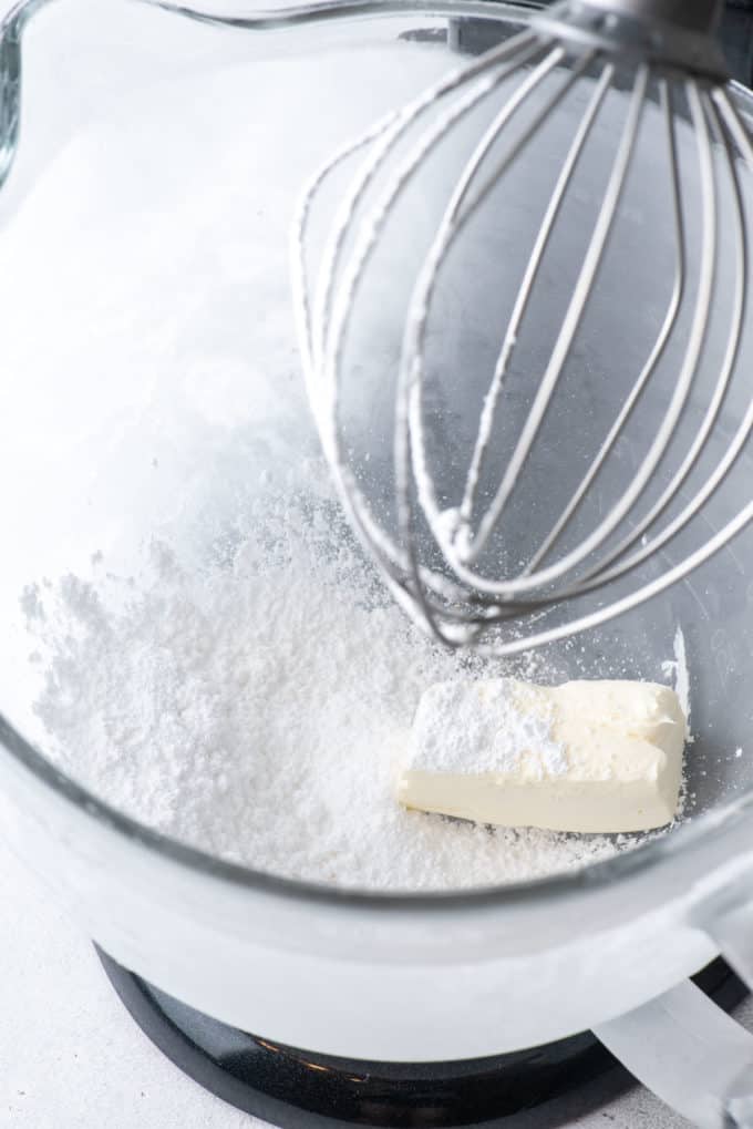 cream cheese and powdered sugar in an electric mixer