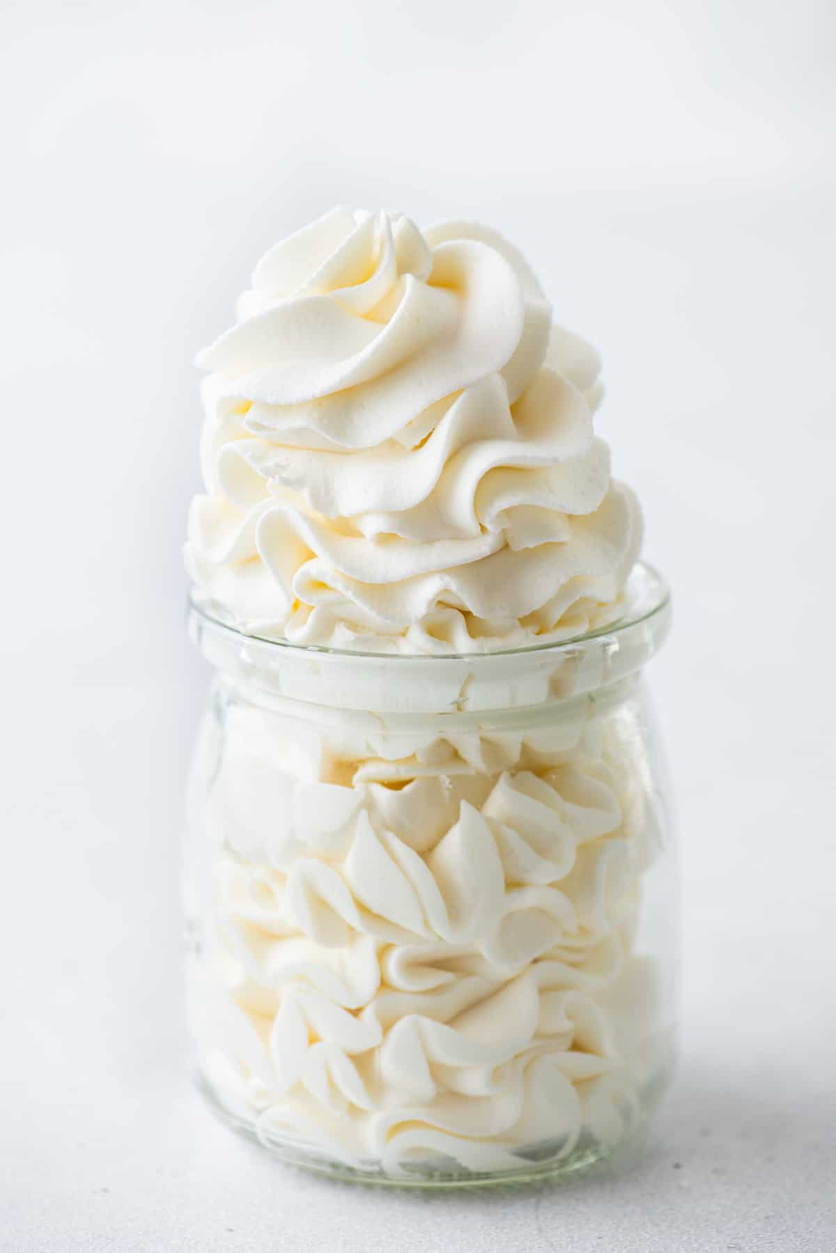 a glass jar full of homemade fresh whipped cream