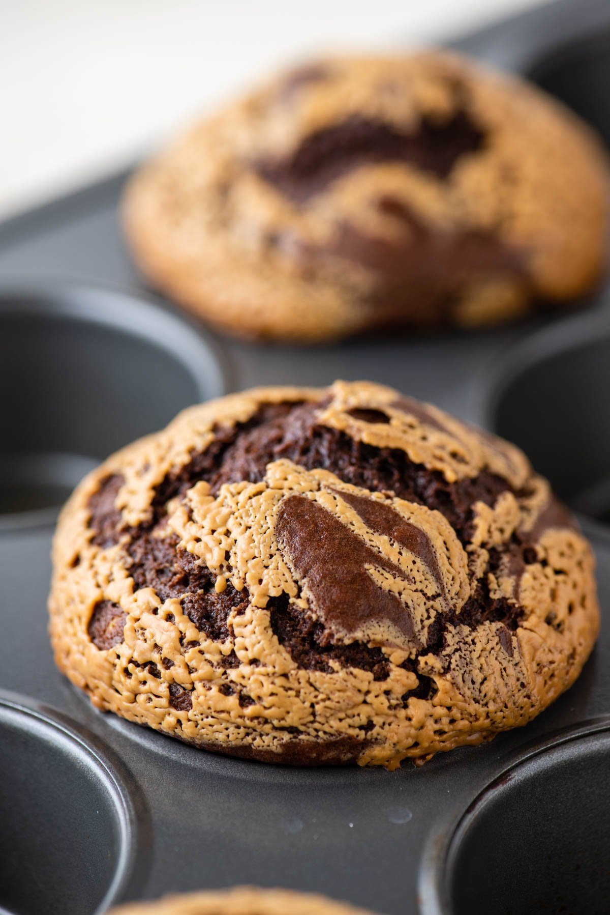 close up of chocolate peanut butter muffins in a muffin tin