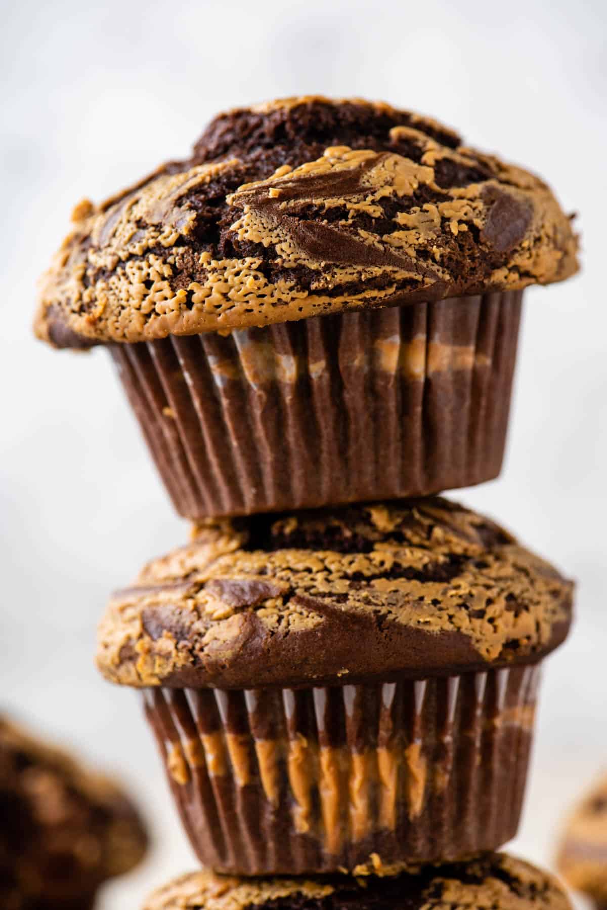 two chocolate peanut butter muffins stacked on top of each other