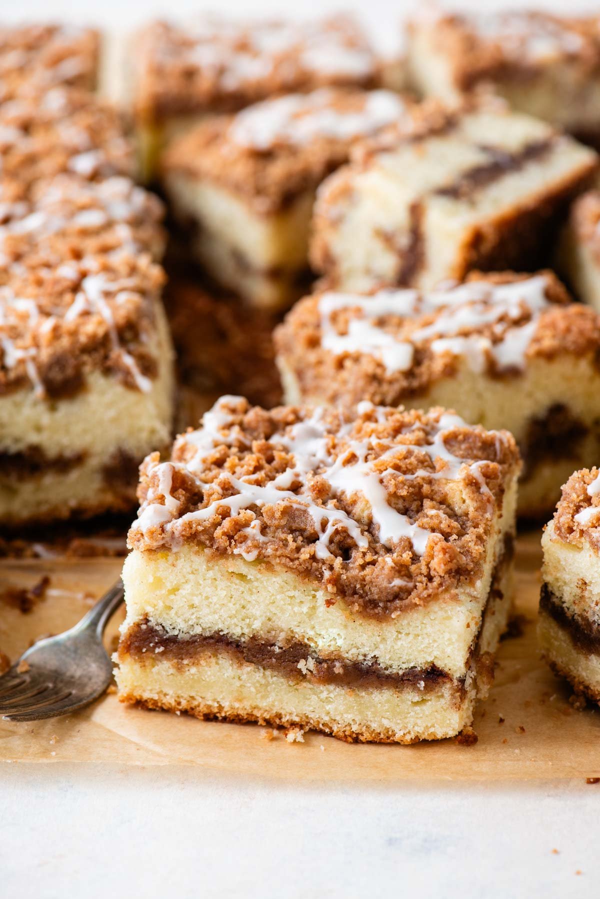 slices of coffee cake arrange on brown paper with a fork in the middle