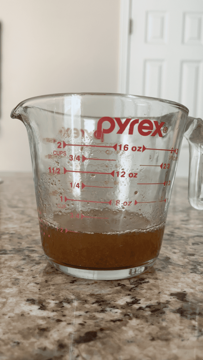 1/2 cup of reduced apple cider in a measuring cup