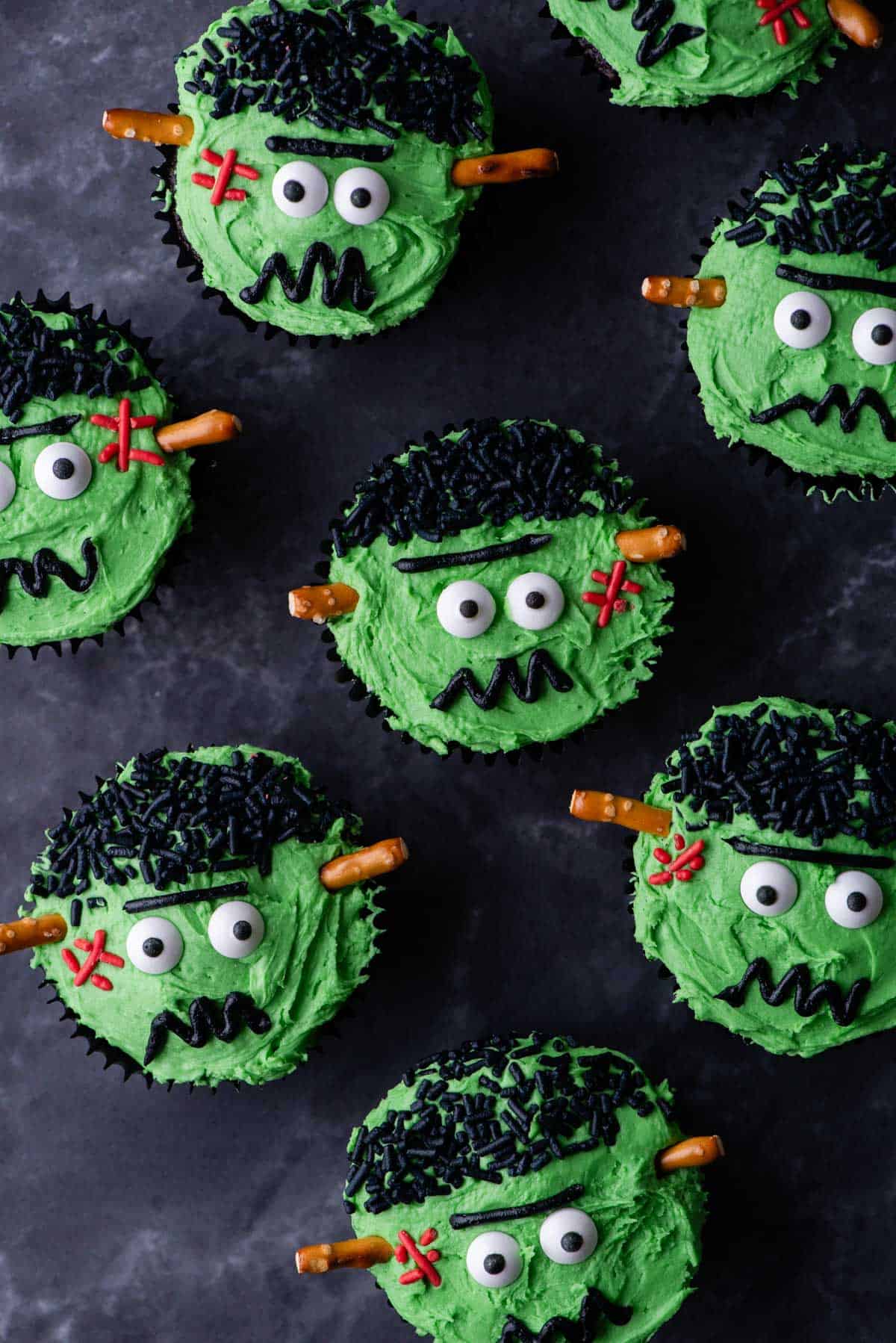 frankenstein cupcakes on a grey surface