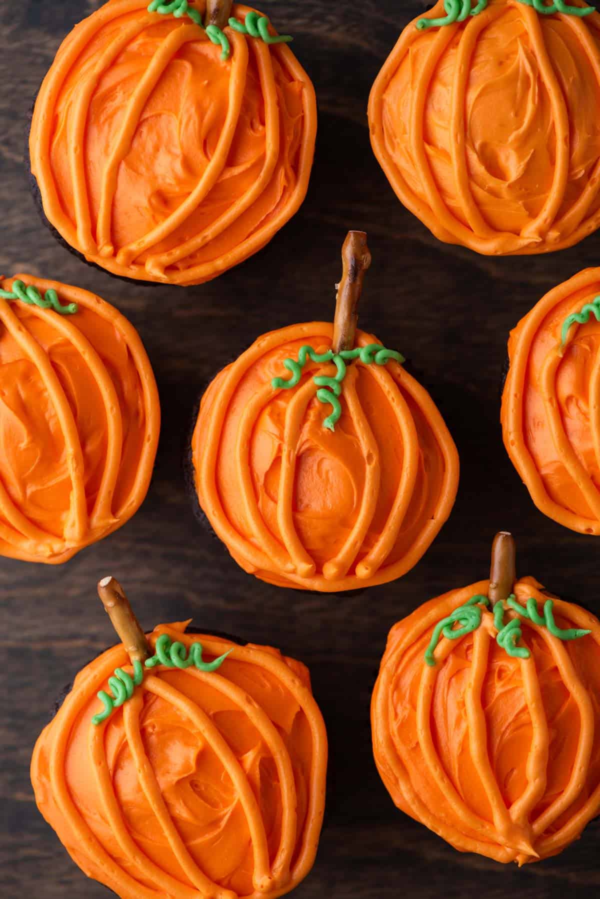 pumpkin patch cupcakes on a wood surface