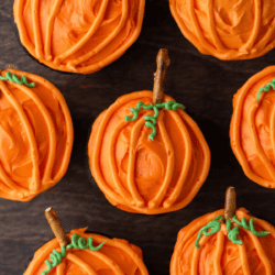 pumpkin patch cupcakes arranged around each other on a wood surface