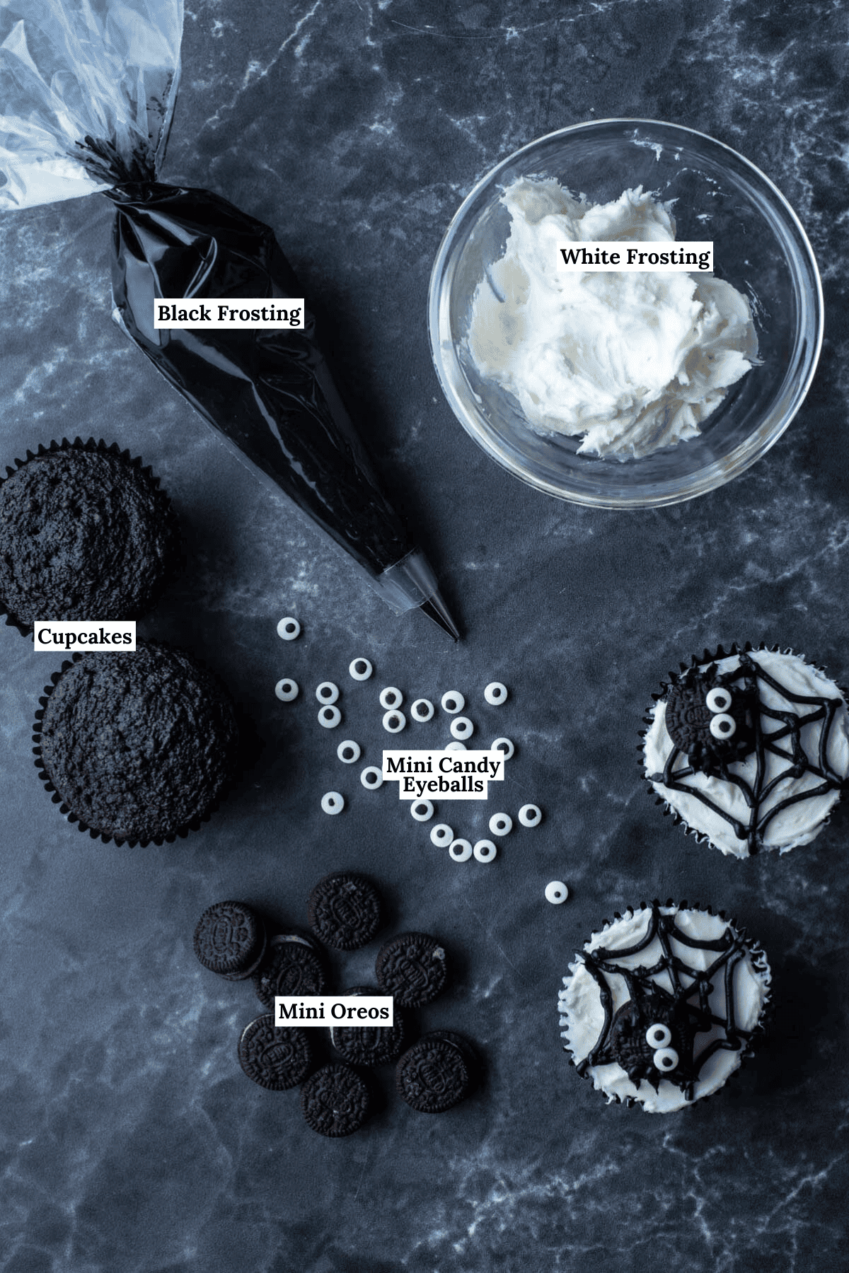 ingredients for spider web cupcakes including white frosting, black frosting, chocolate cupcakes, mini candy eyeballs, and mini oreos