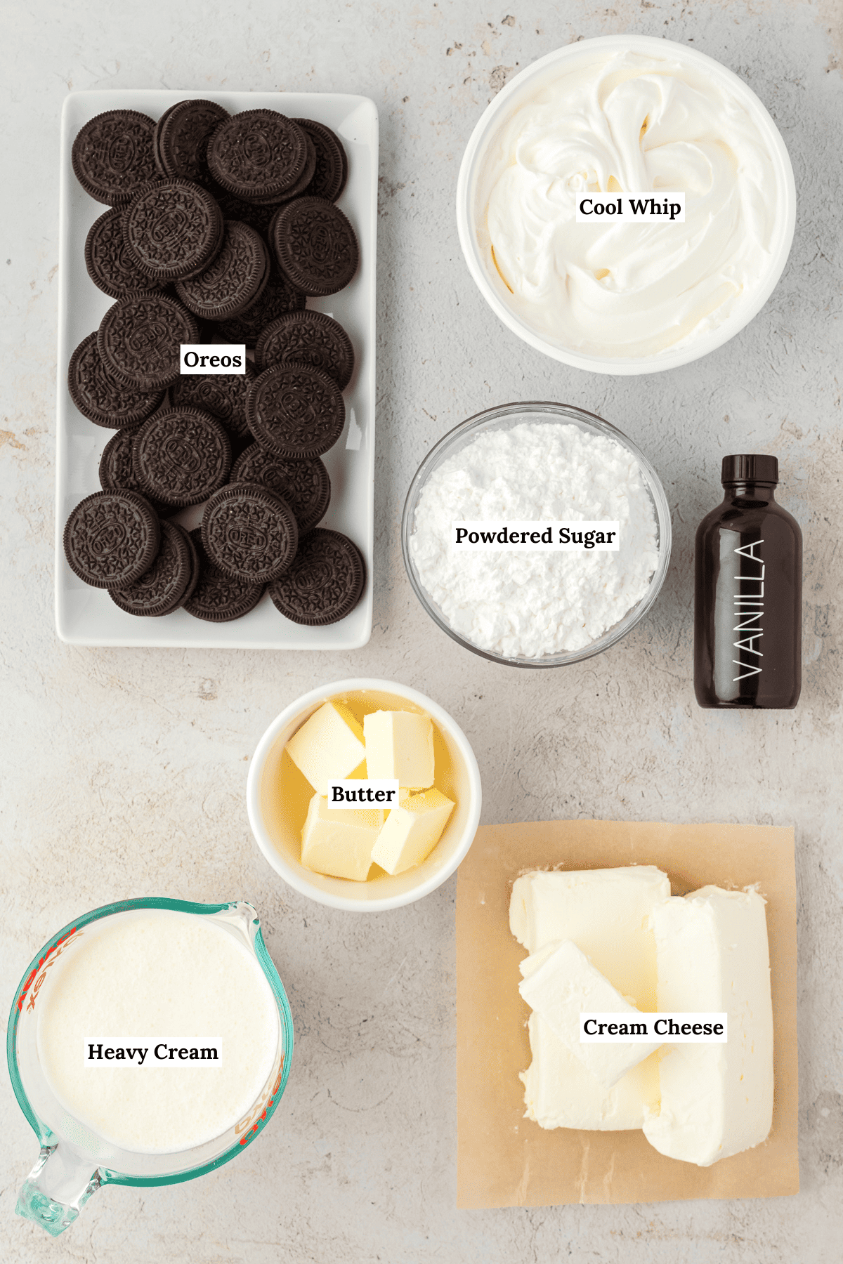 oreo pie ingredients including oreos, cool whip, powdered sugar, vanilla extract, cream cheese, heavy cream and butter