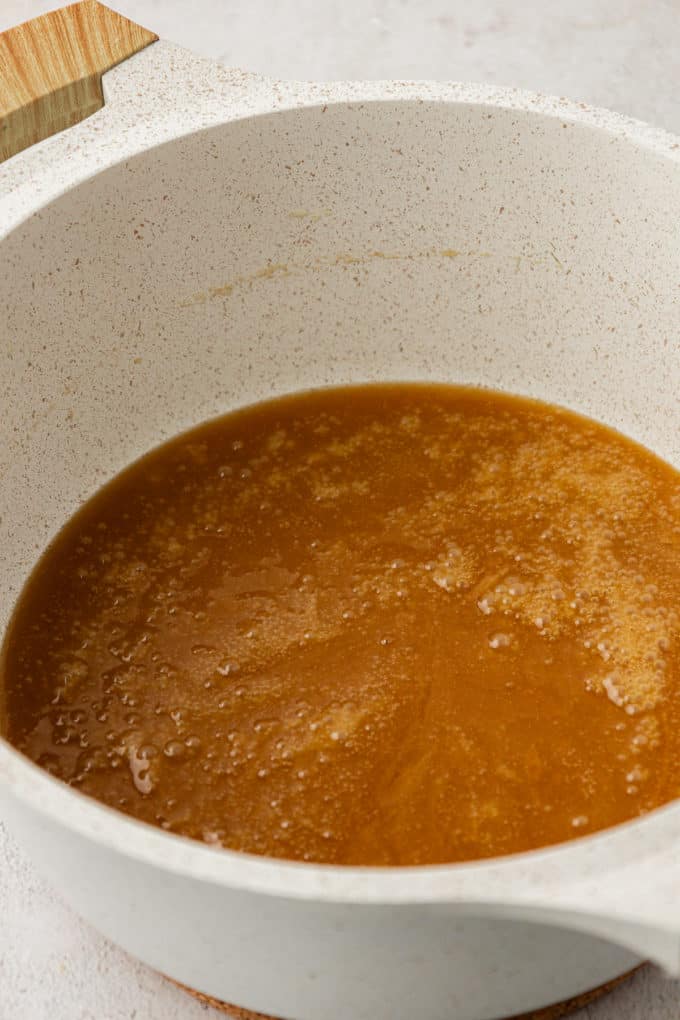 a brown sugar and butter mixture melted in a white pot