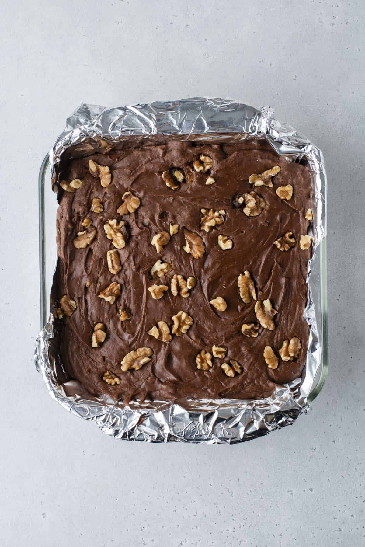 a pan lined with aluminum foil full of fantasy fudge that hasn't been sliced yet