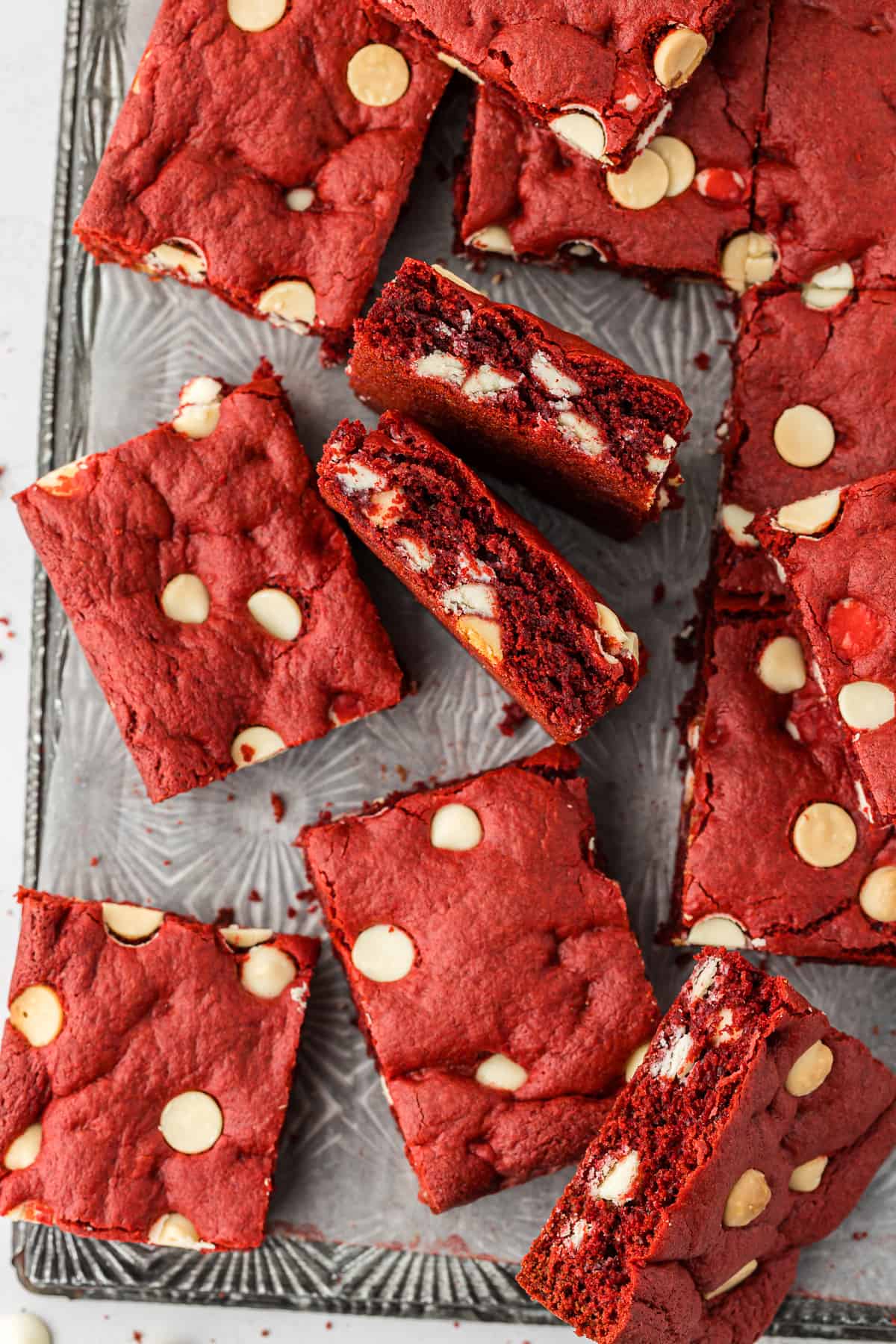 red velvet cake mix cookie bars on a silver tray, some laying flat and some up on their sides