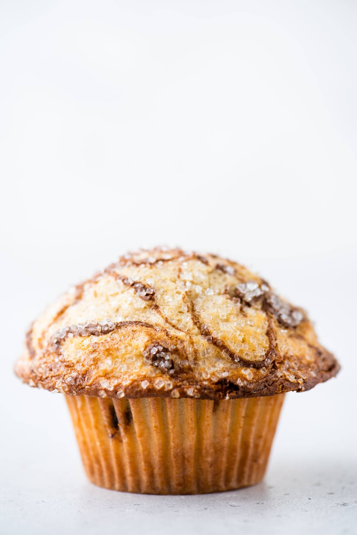a nutella swirl muffin sitting on a white surface with a white background