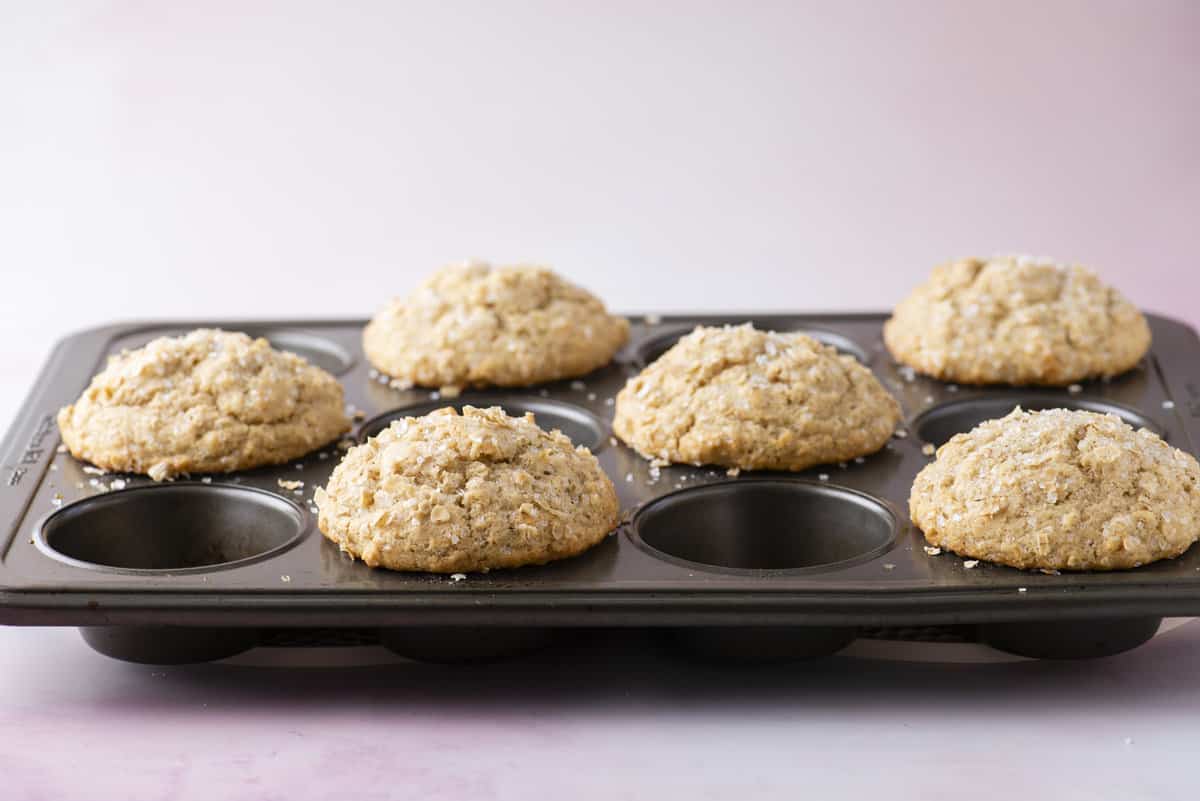 side view of a muffin pan with oatmeal muffins in every other muffin hole