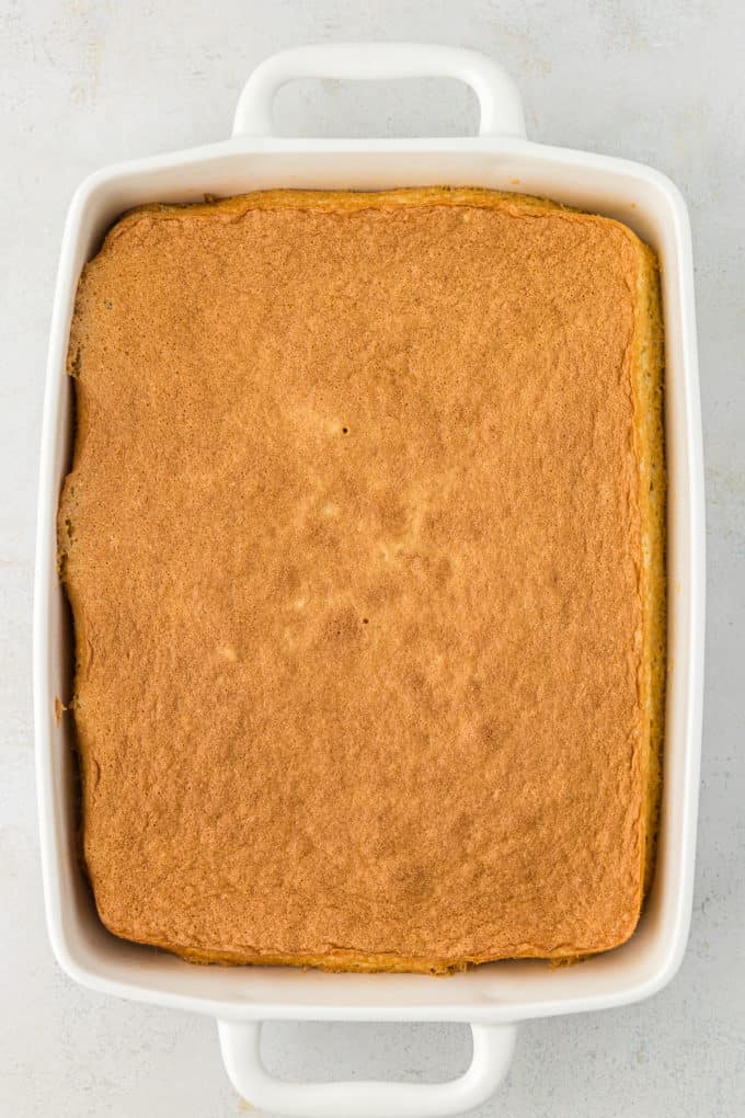 a freshly baked cake in a white baking dish