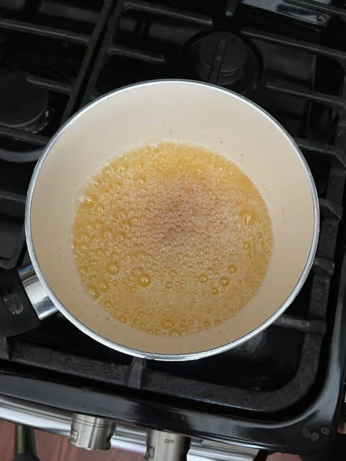 melted butter starting to brown in a small pot on a stovetop