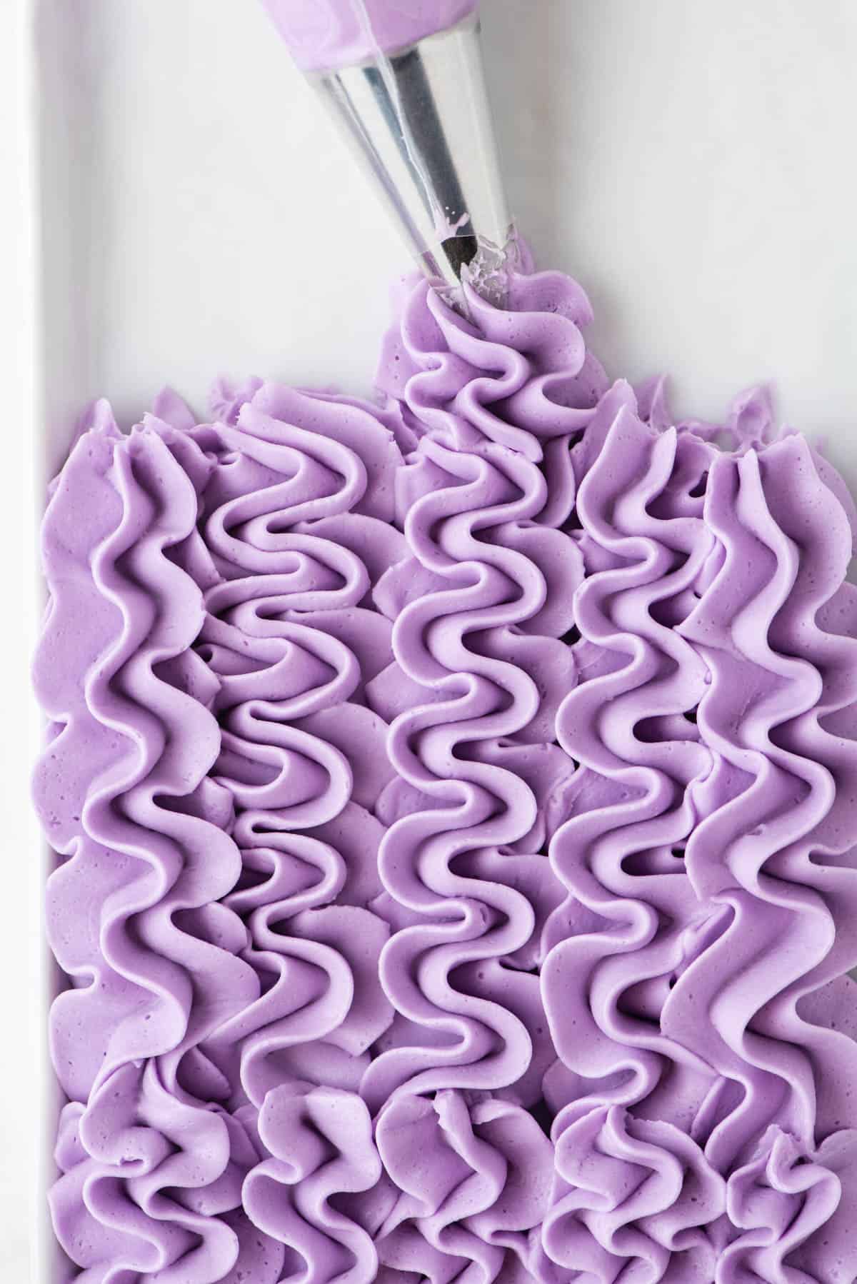 light purple frosting piped in rows with a piping bag