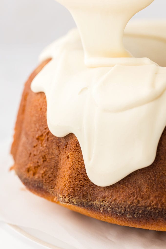 vanilla glaze dripping down the sides of a vanilla bundt cake