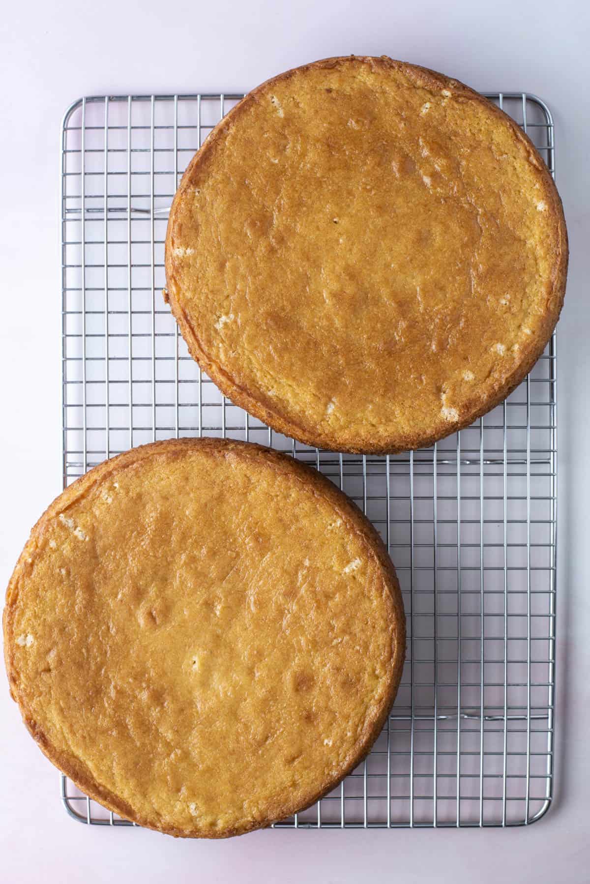 two round cakes on a wire cooling rack