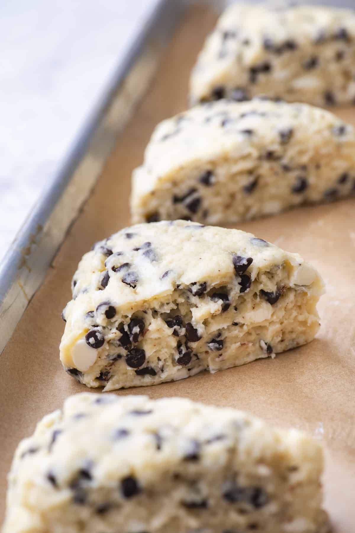 chocolate chip scones on a baking sheet lined with parchment paper ready to bake