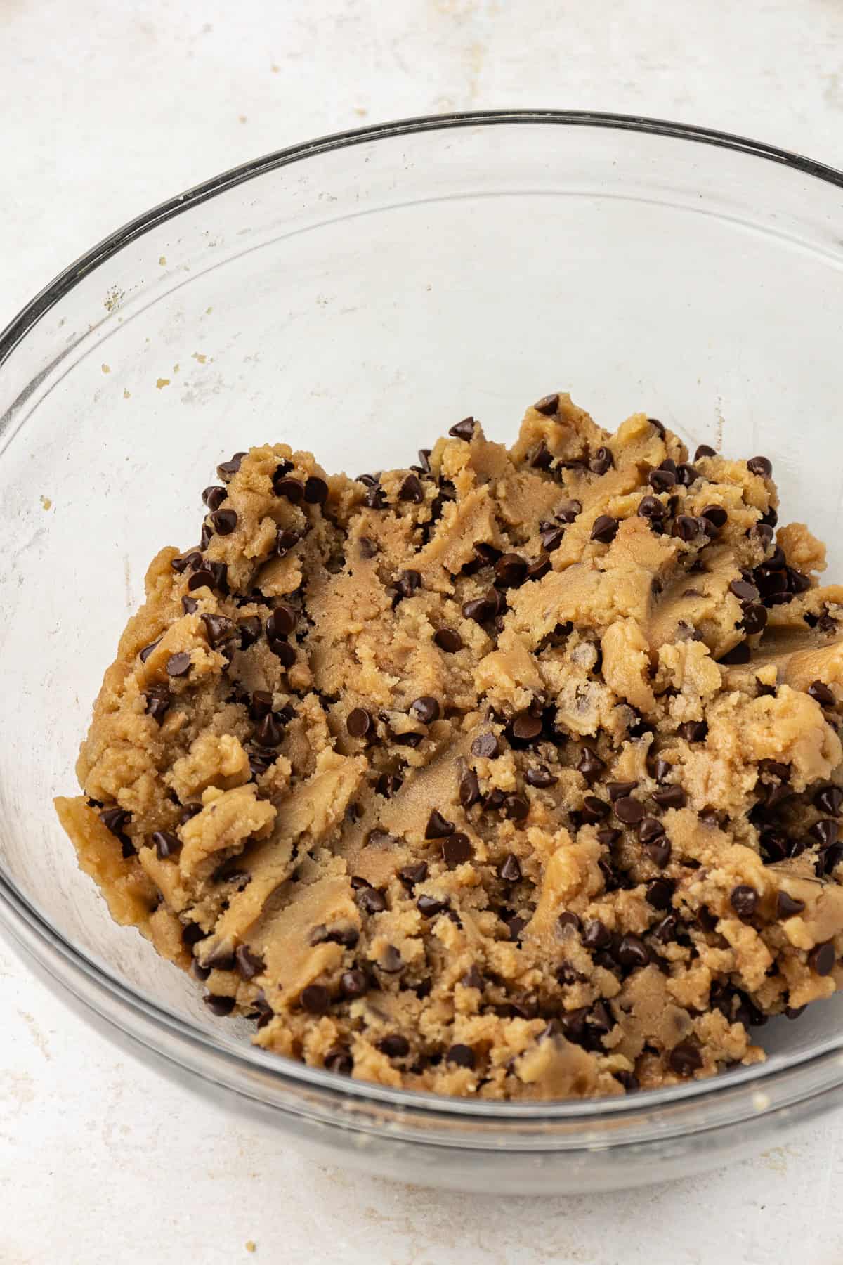 chocolate chip cookie dough in a clear glass bowl