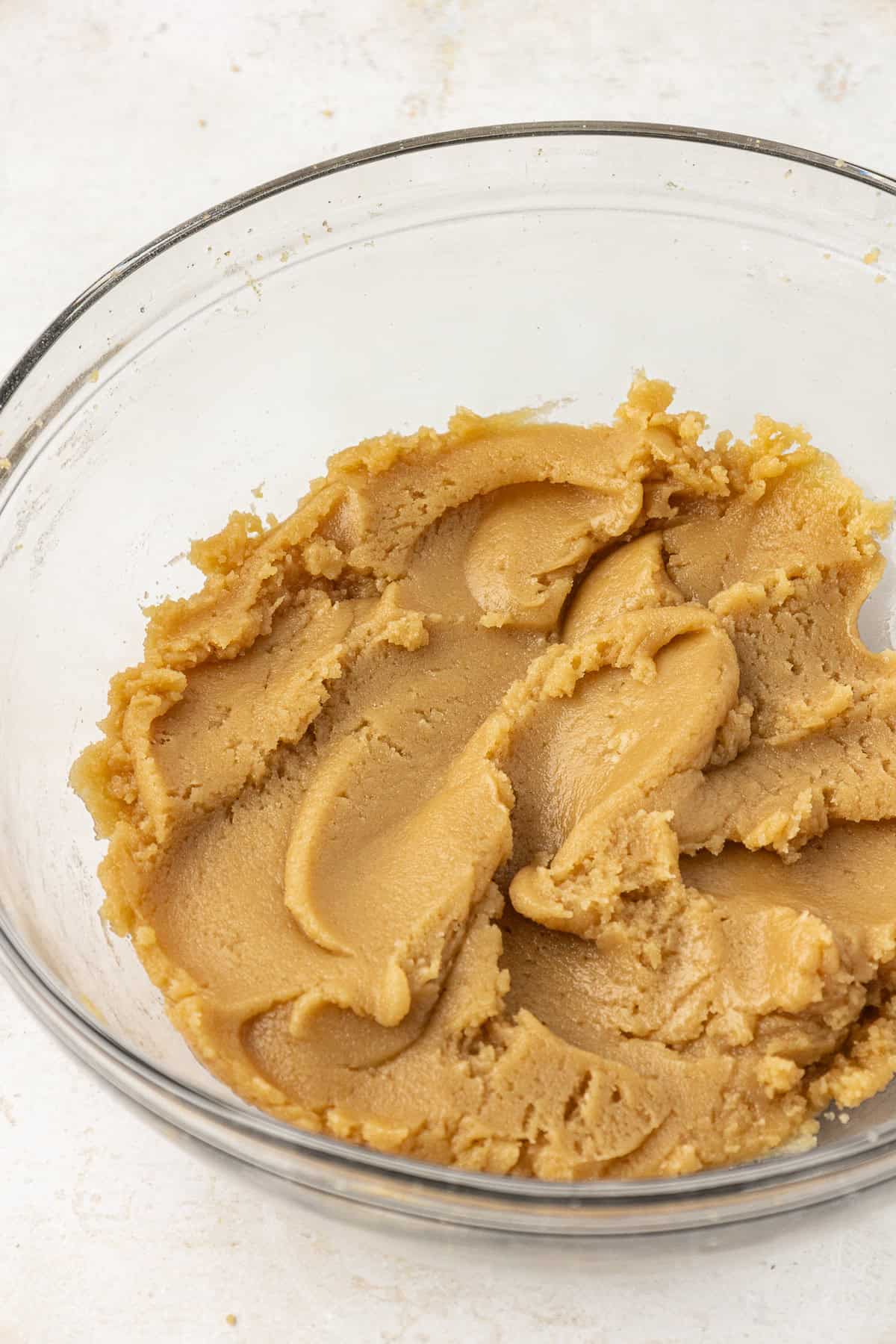 edible cookie dough base mixed together in a clear glass bowl