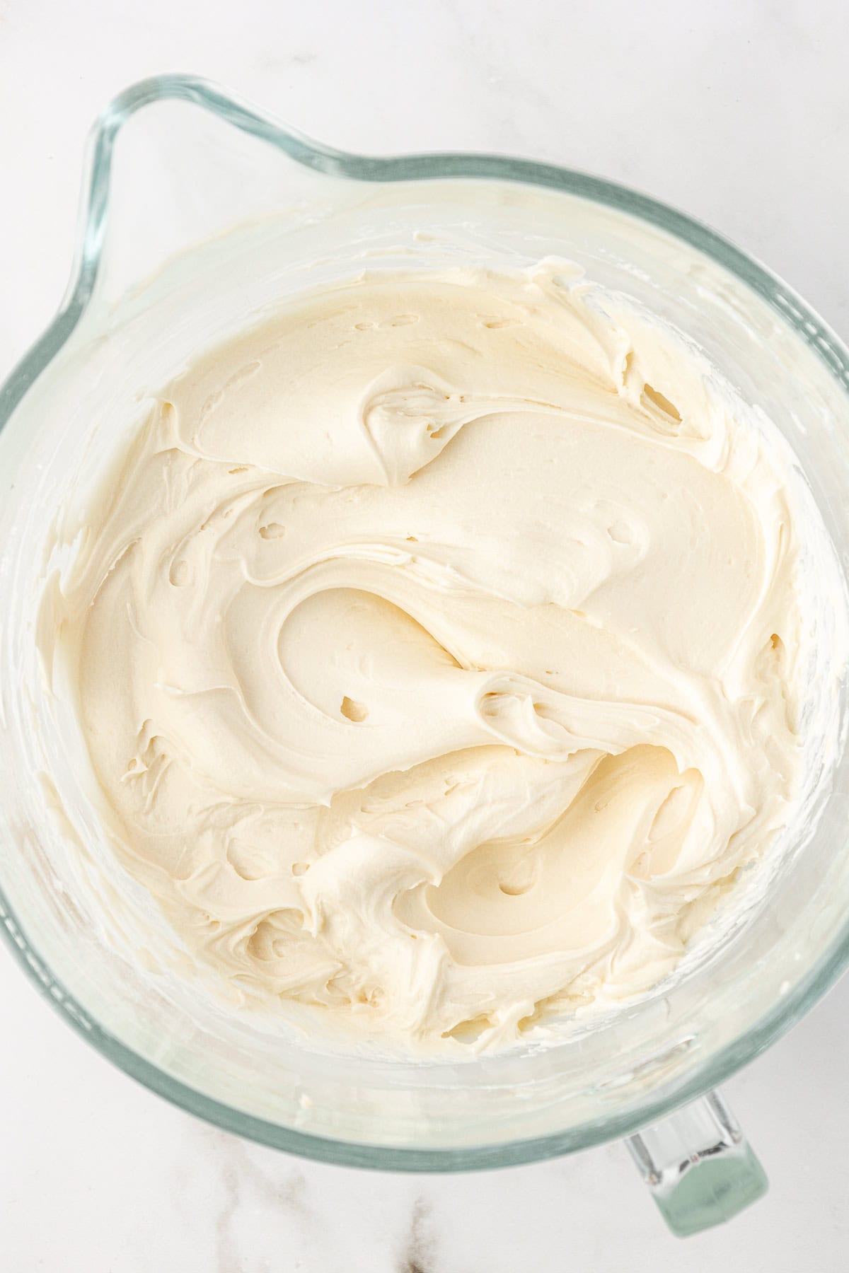 vanilla frosting in a clear glass bowl