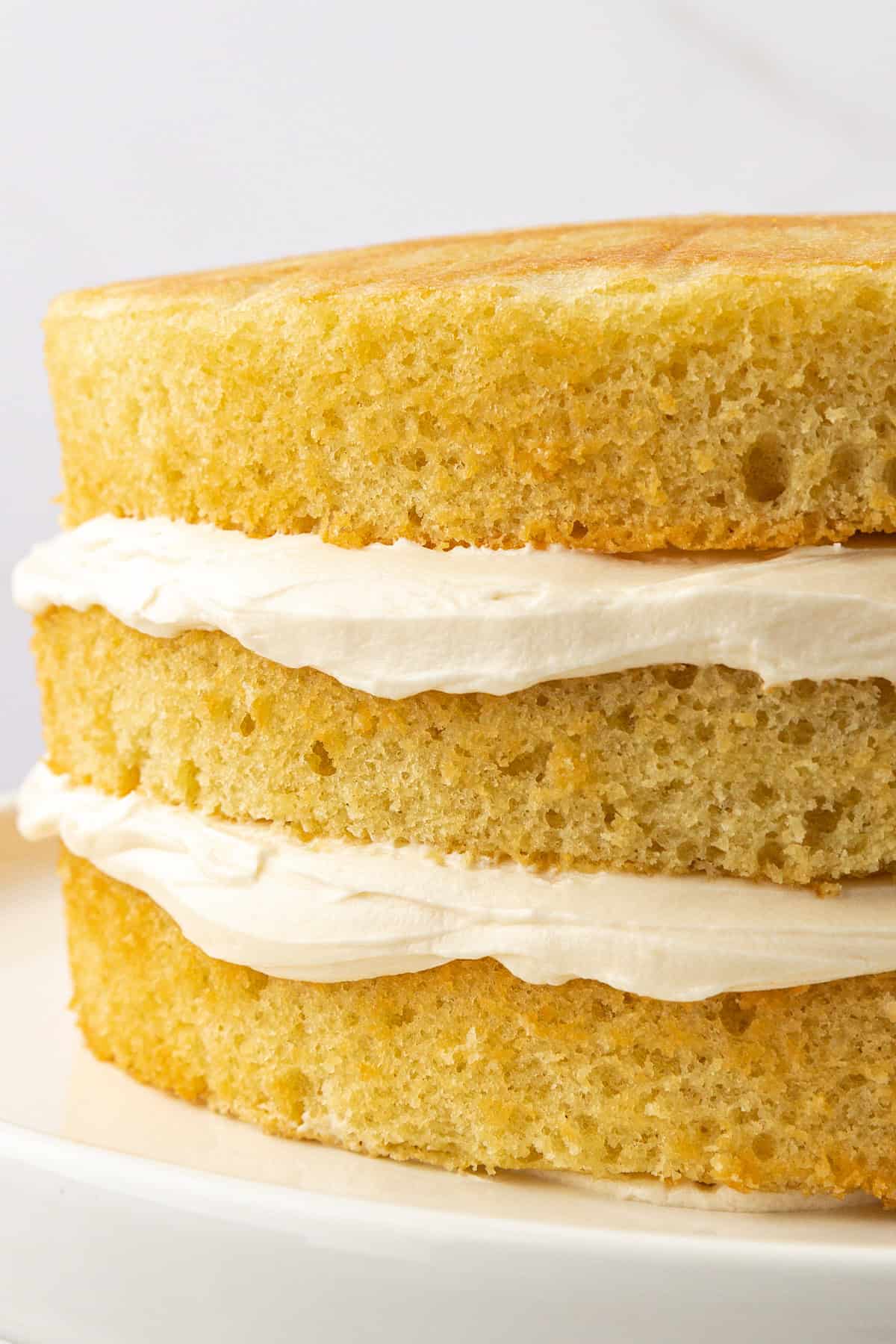 three layers of vanilla cake with vanilla frosting between them