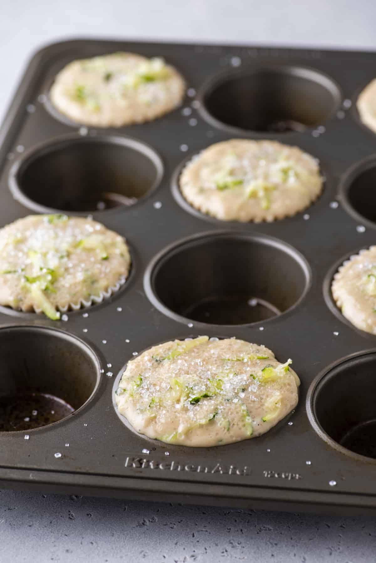 zucchini muffin batter in every other muffin whole of a muffin pan