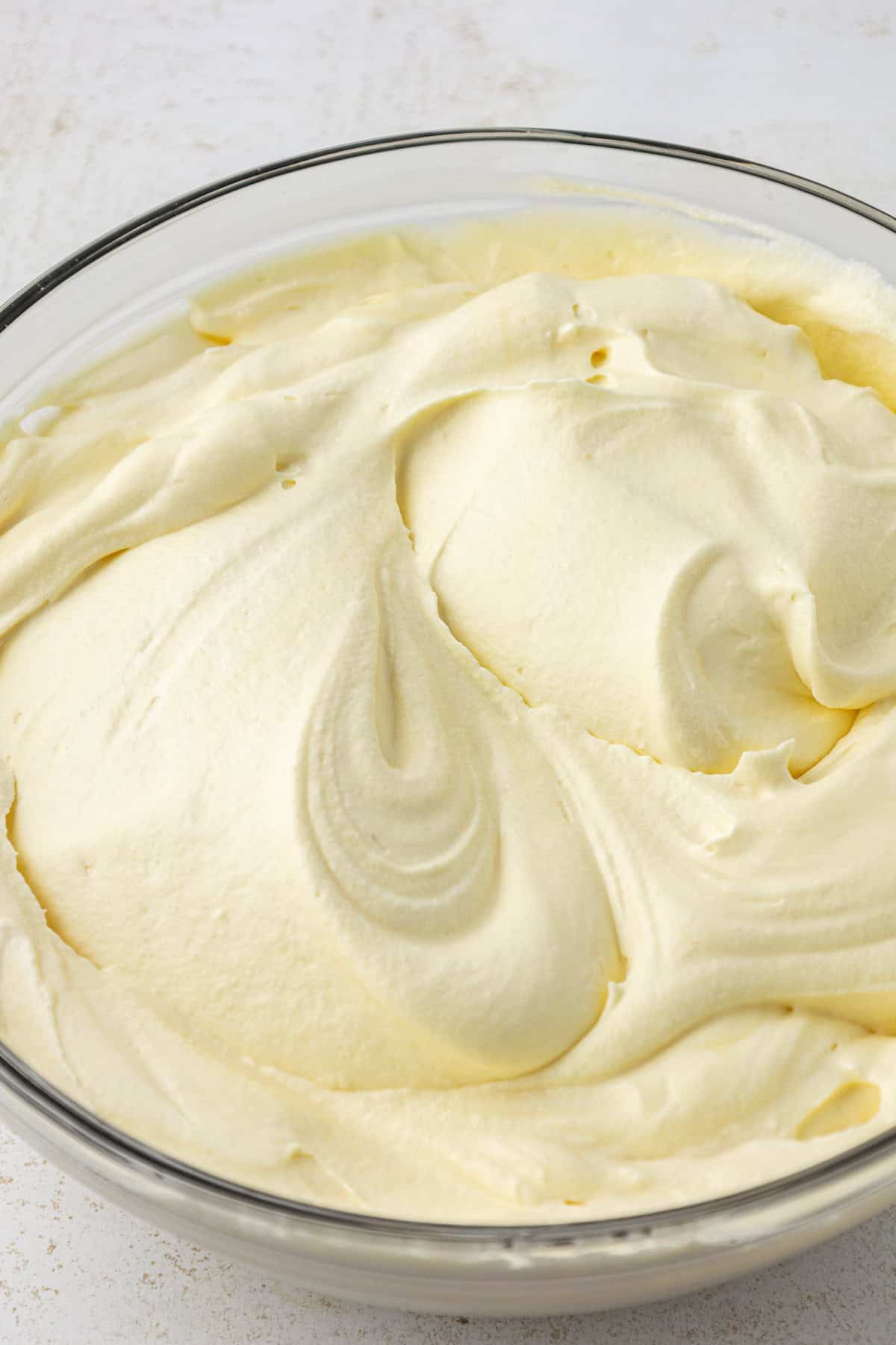 milk and vanilla instant pudding mixed in a large clear glass bowl