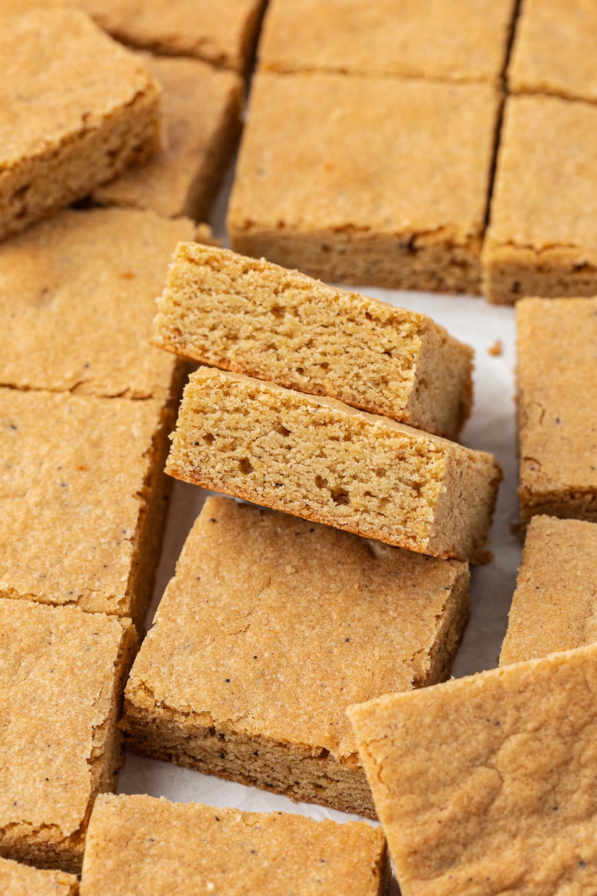 Blondies in rows and scattered around, with the center two leaning on each other and another blondie, showing the side-view.