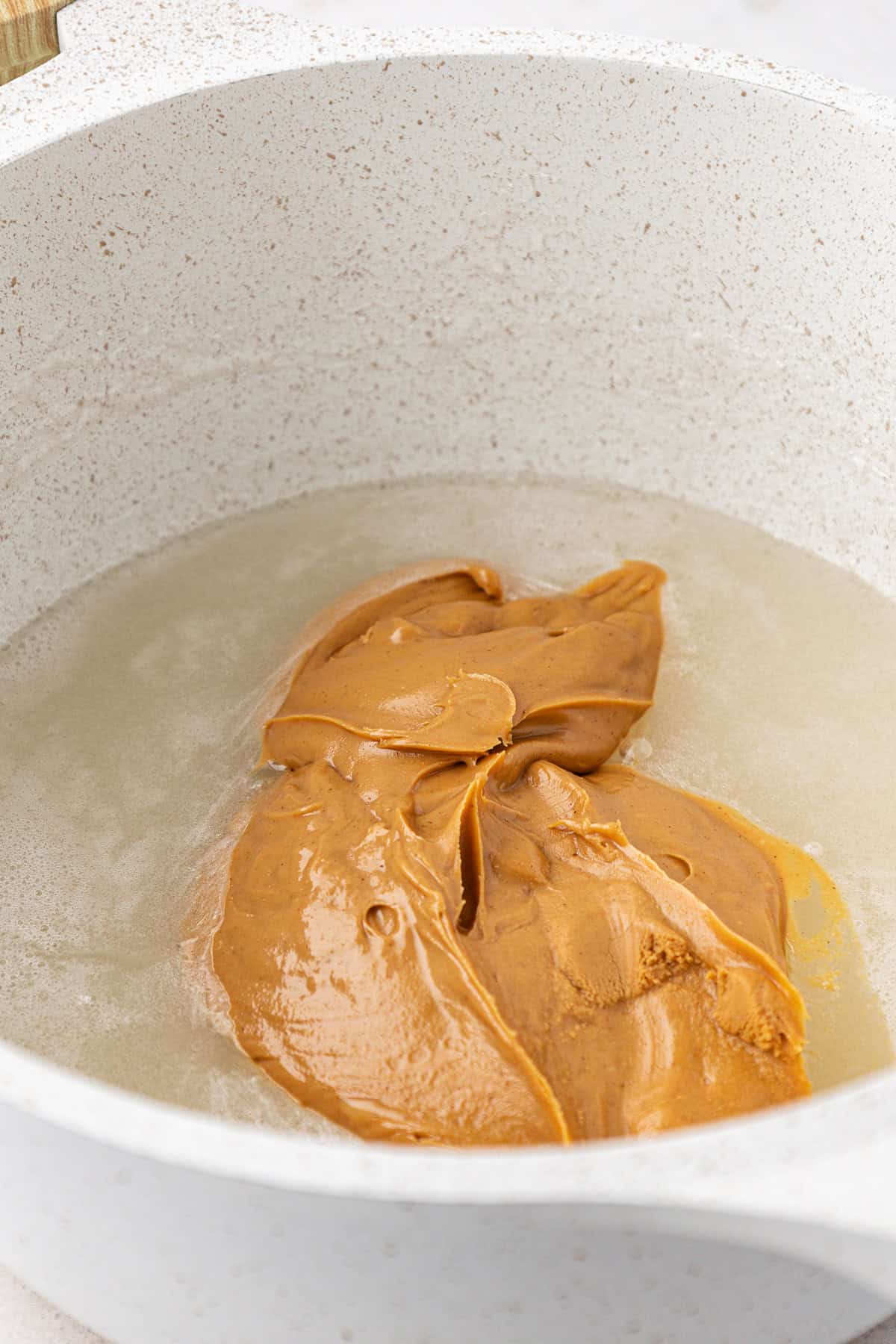 creamy peanut butter in a pot with a sugar and corn syrup mixture