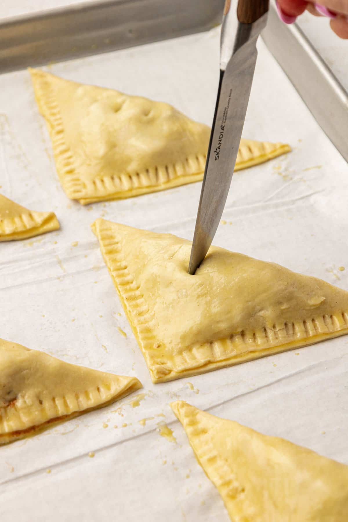 venting apple turnovers with a sharp knife