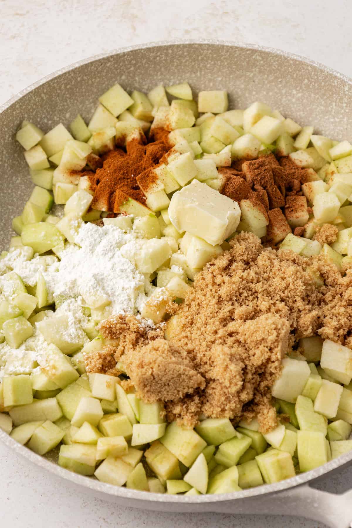 diced apples, sugars and spices in a large bowl