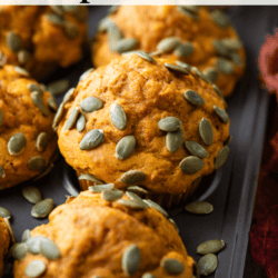 close up of healthy pumpkin muffins topped with pumpkin seeds in a muffin pan