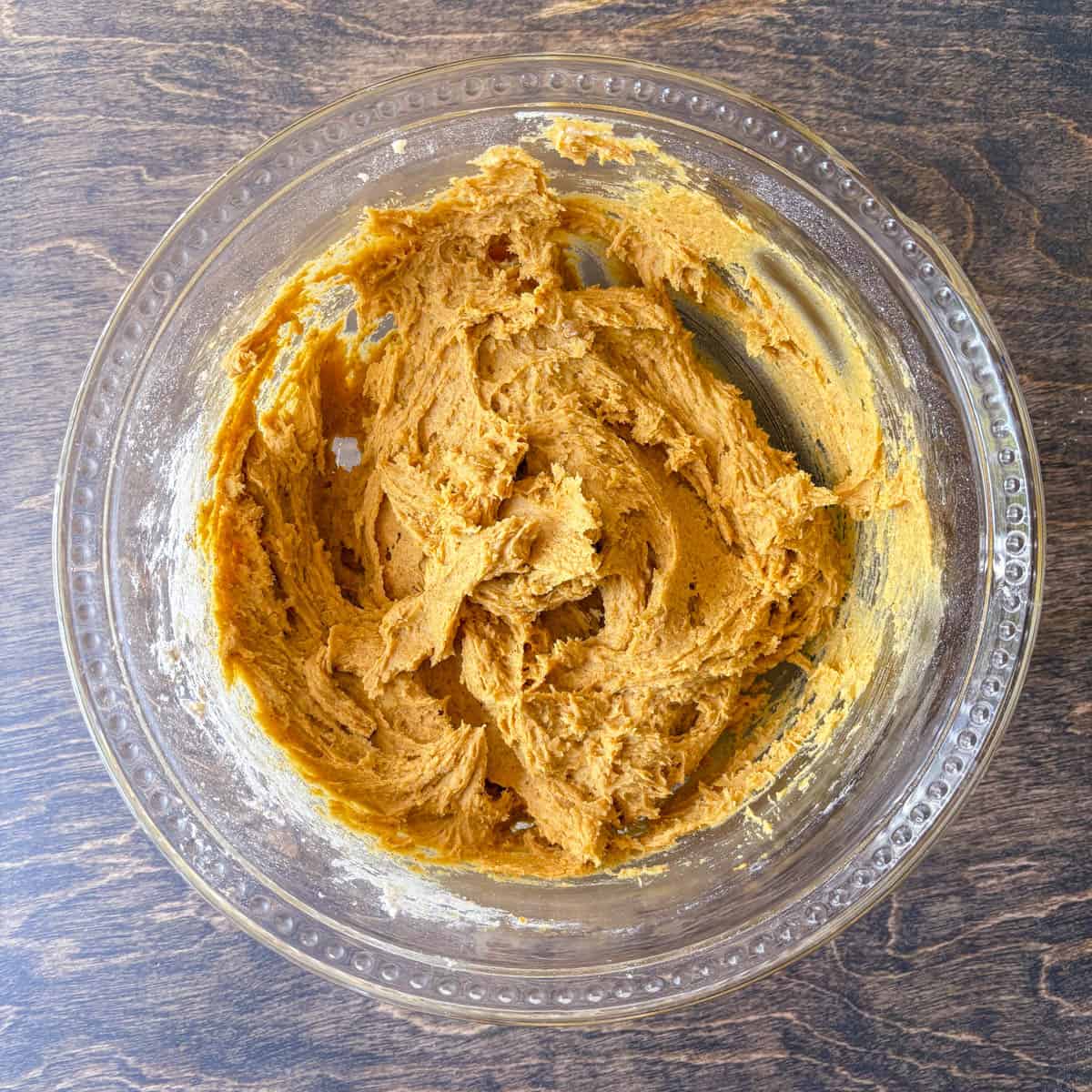 pumpkin cookie dough in a clear glass bowl