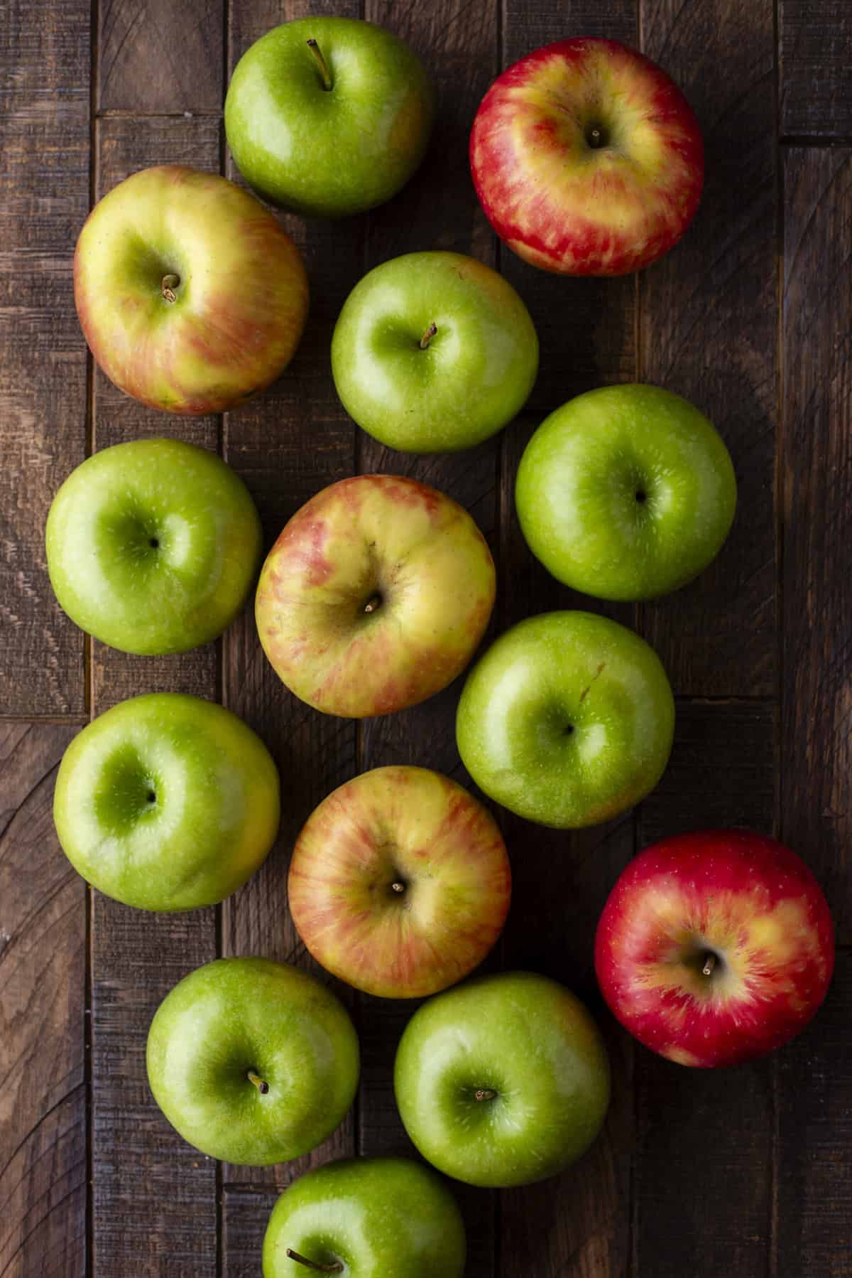 over head view of green and red apples on a wood surface