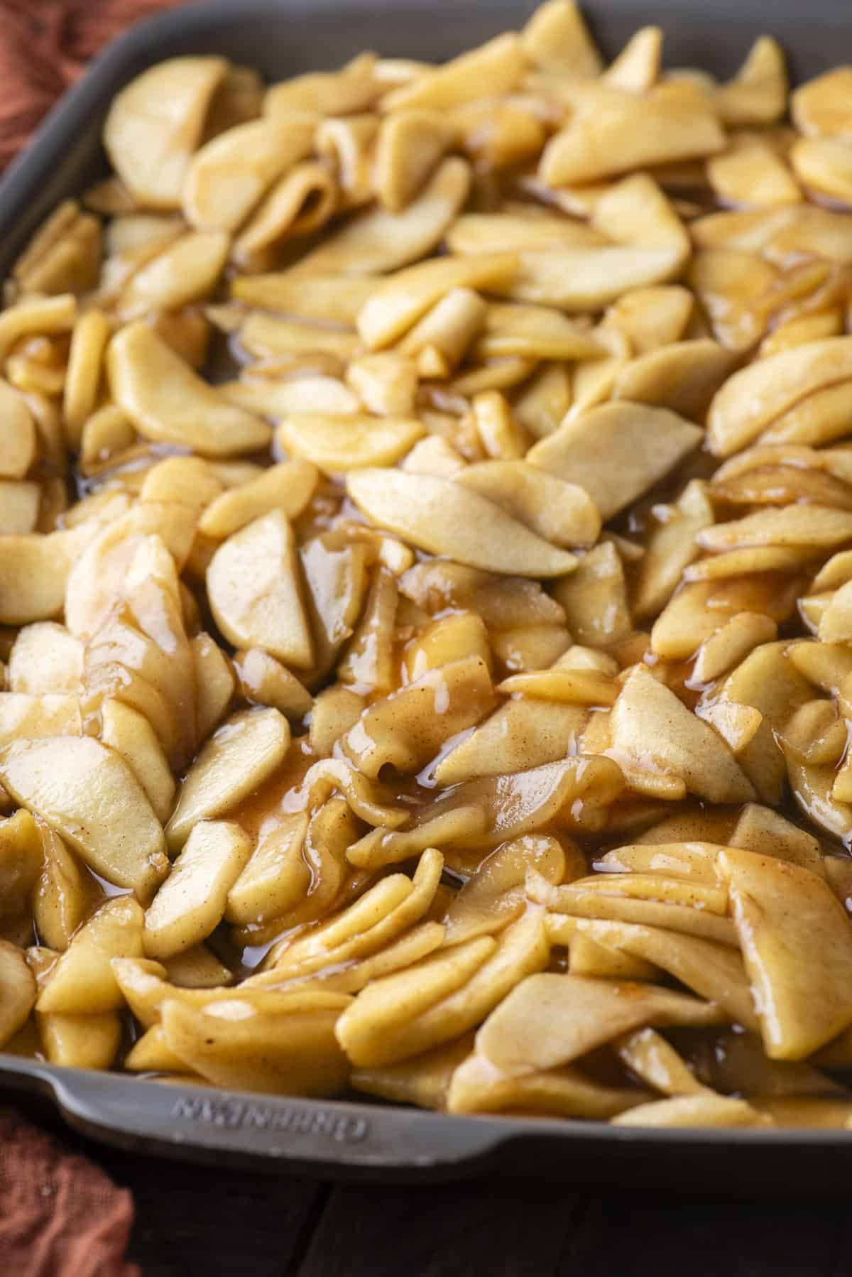 apple pie filling spread over a baking sheet