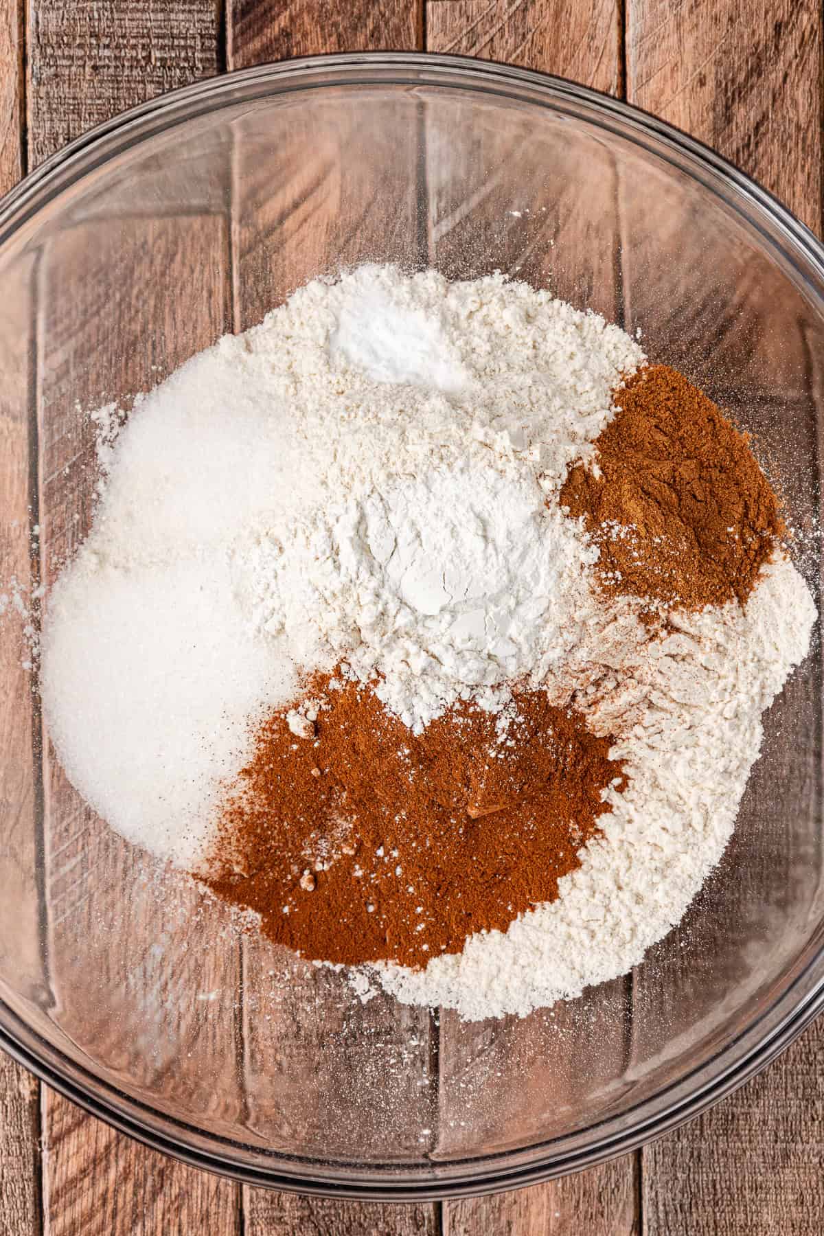 dry ingredients for pumpkin pancakes in a clear glass bowl