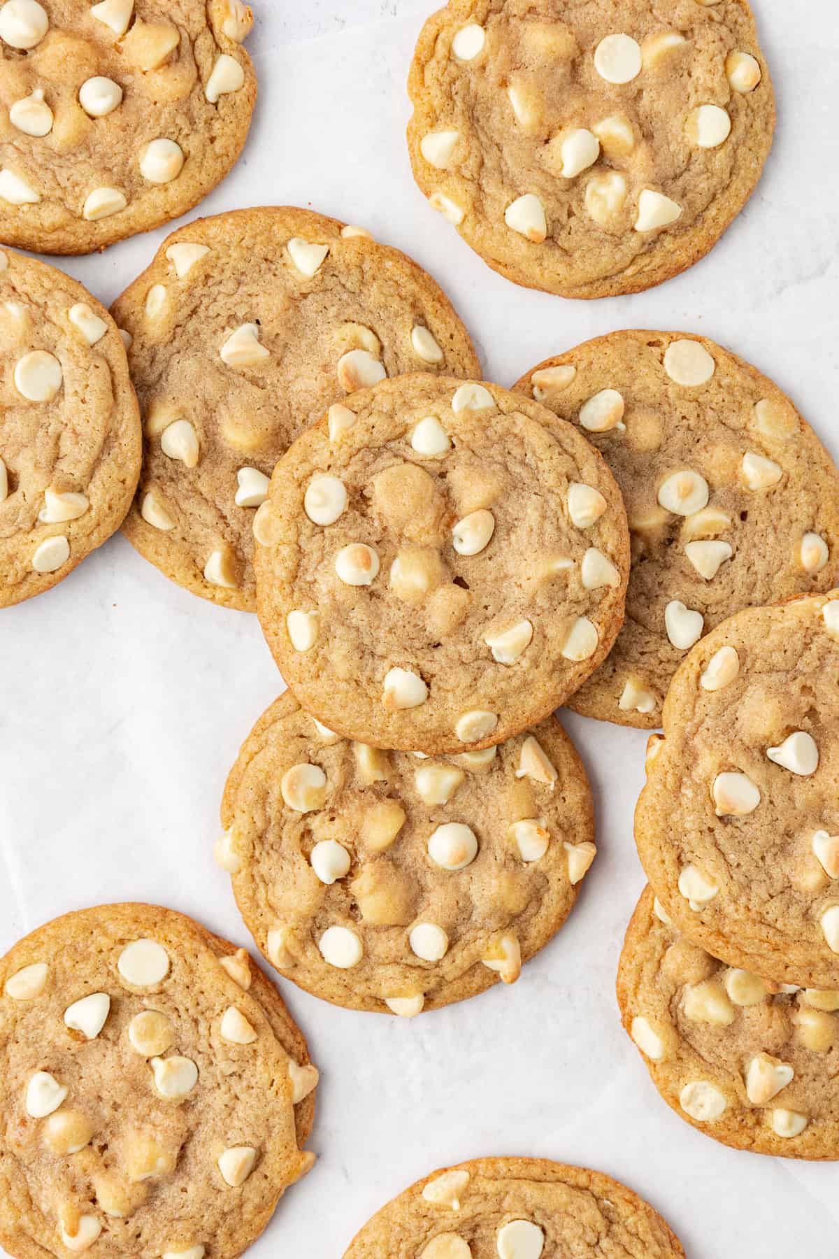 over head view of scattered white chocolate chip cookies