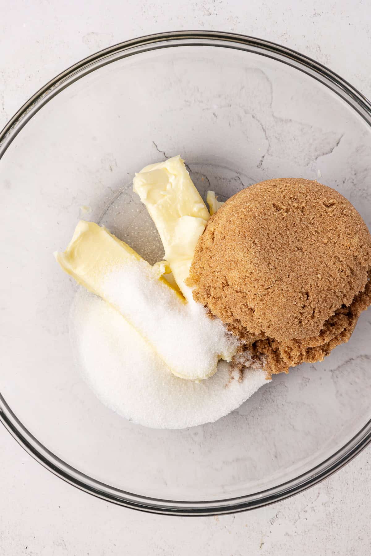 butter, granulated sugar and brown sugar in a clear glass bowl