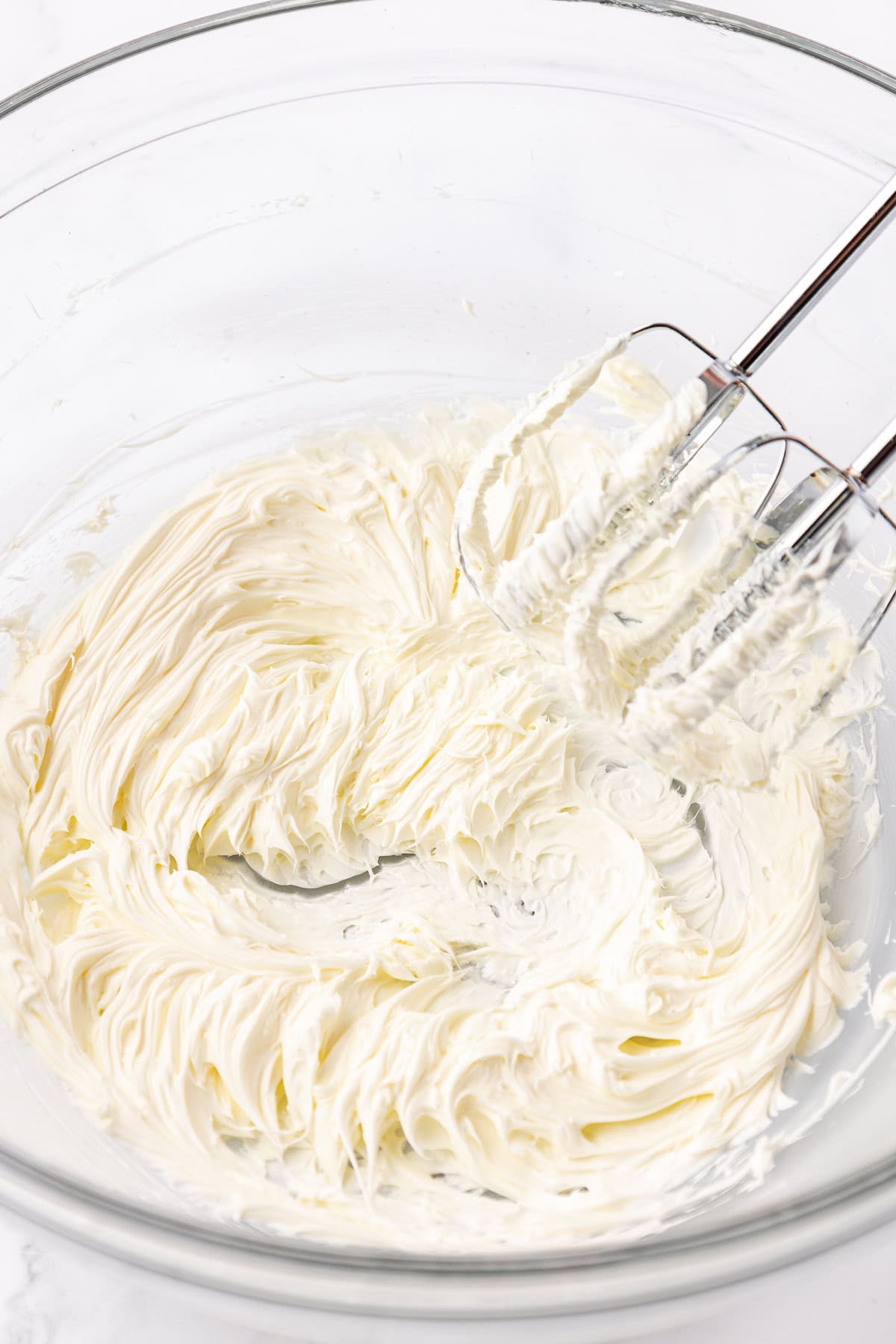 butter mint ingredients being creamed in a class bowl