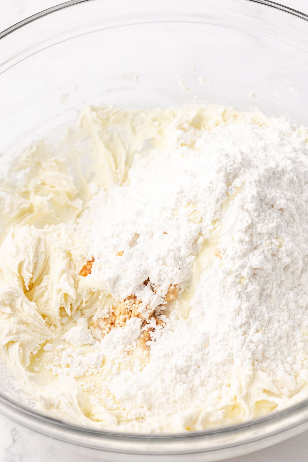 ingredients for butter mints in a clear glass bowl not yet combined