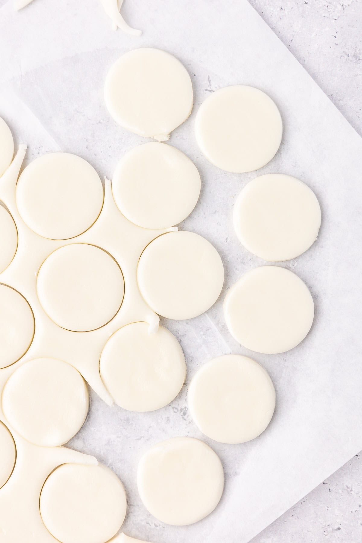 peppermint patty filling rolled out flat on white parchment paper and cut into round discs