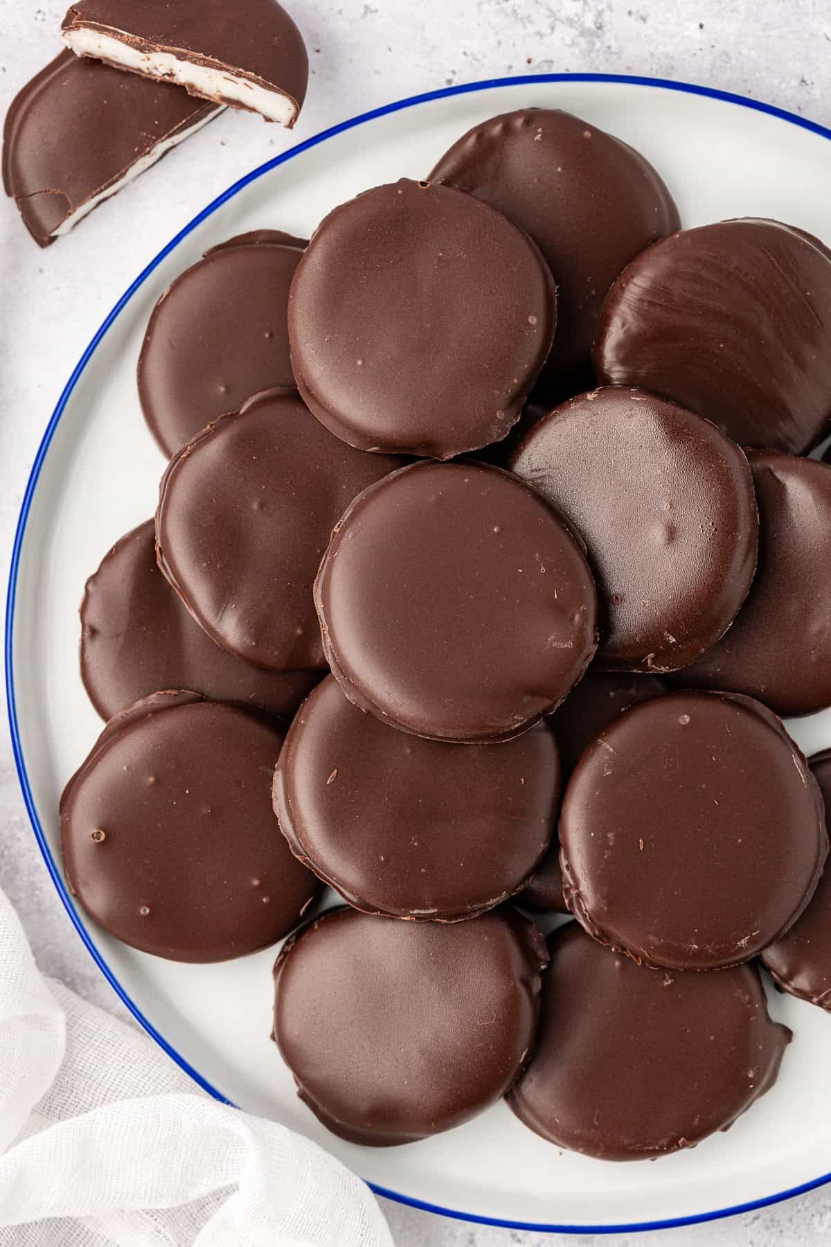 over head view of a large white plate with a blue rim filled with peppermint patties