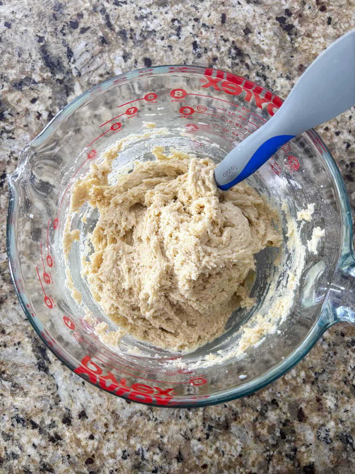 donut dough in a measuring cup on a countertop