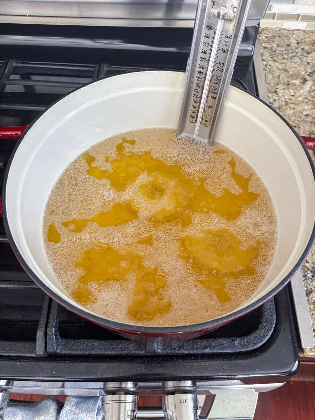 hot pot of oil with a thermometer attached to the side